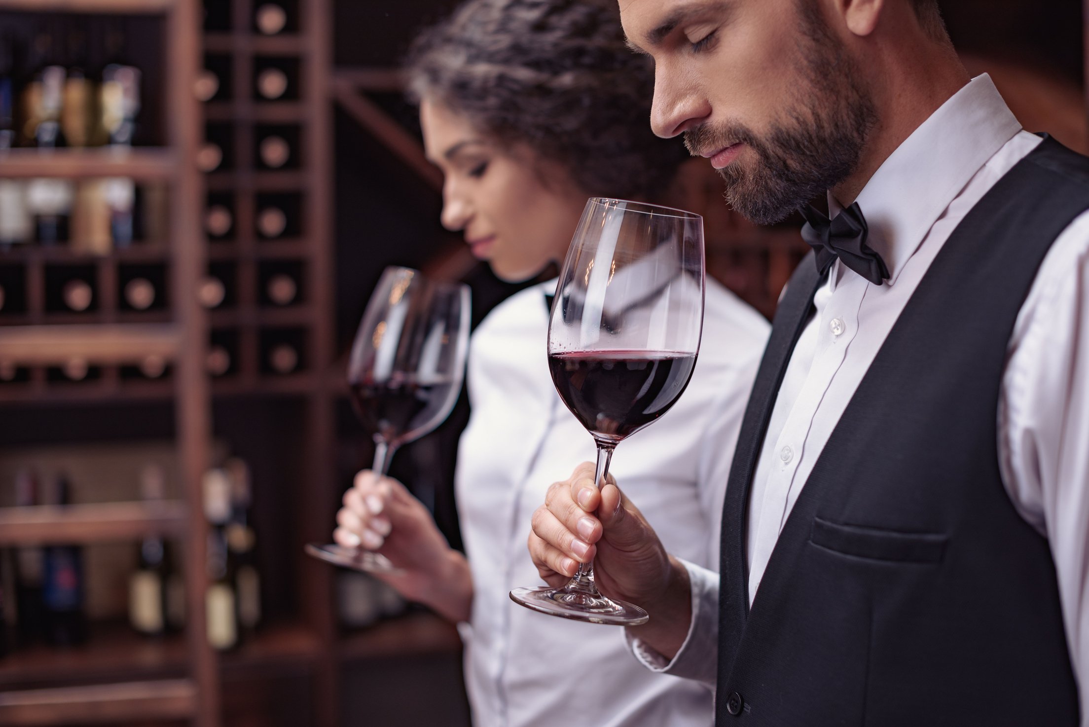 Sommeliers tasting wine in cellar